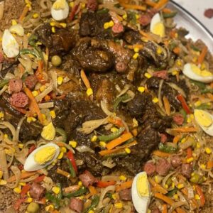Thiébou yapp : riz à la viande garni de légumes, œufs durs, olives et merguez